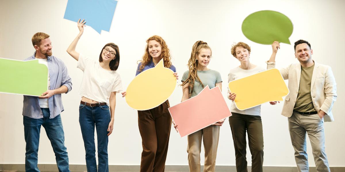 Group of people holding large speech bubbles.