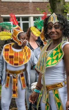 Children dressed in white with colourful Caribbean accessories at 2017 parade.