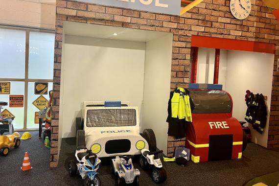 Kinder Hubs Police and Fire play area with rideable police bikes and fireman clothing