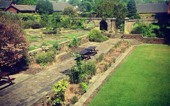 The Space Centre's walled garden area with grassy areas and picnic tables