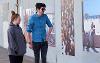Young couple looking at photography in a pubic space