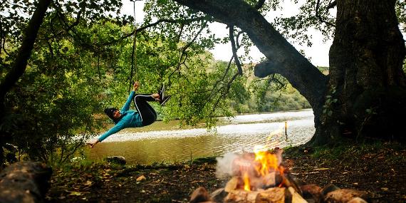 Woman having fun on rope swing