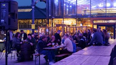 People enjoying drinks at The Orchard's outdoor seating area