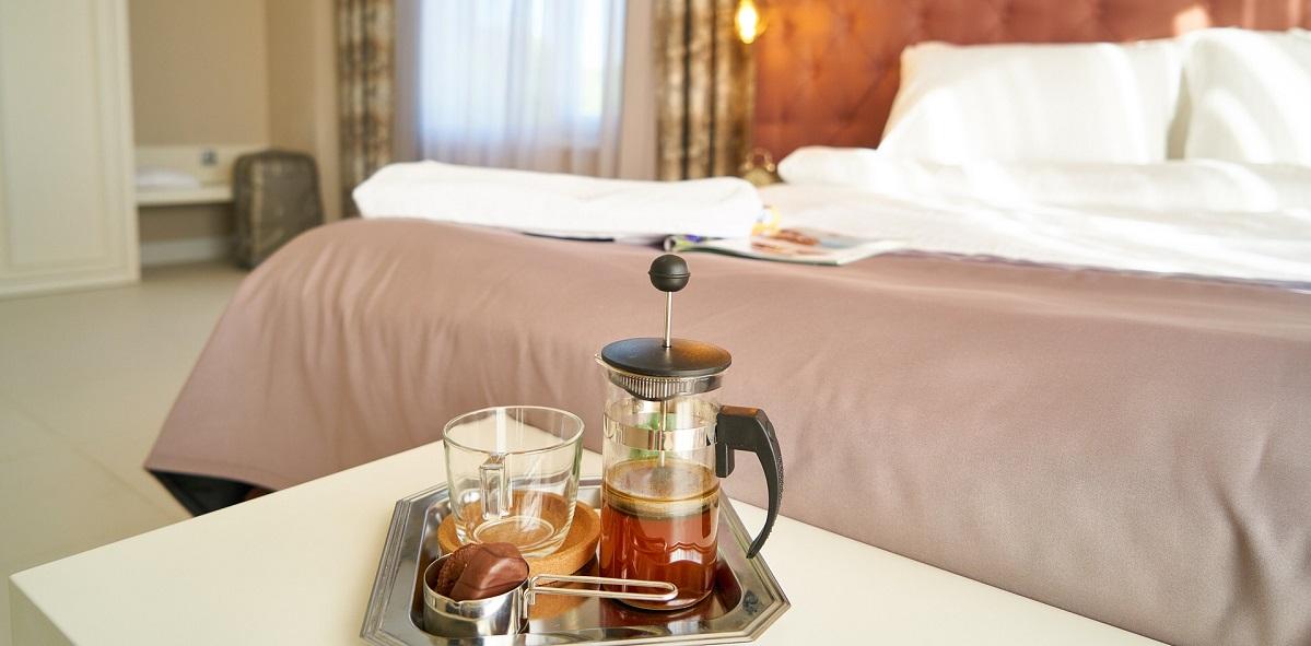 Cafetiere and cup on bedroom table