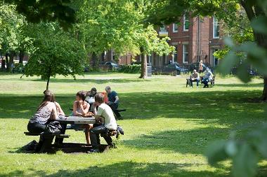 Young people sat on bench at Winckley Square Gardens