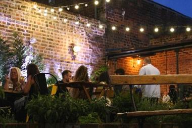 People in Lost Bar and Pizzeria courtyard