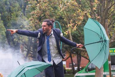 FLOOD performer with umbrella