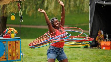 Woman hula hooping with lots of hula hoops