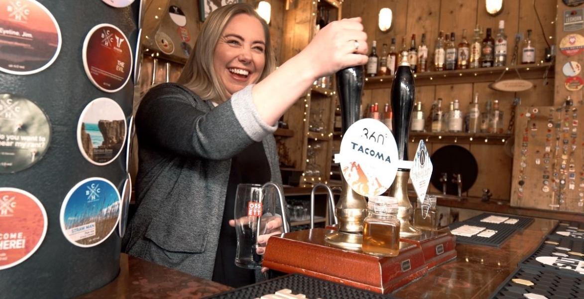 Bartender pulling a pint at The Orchard