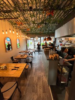 A view of the seating area and serving bar of Chamo Street Food in Preston