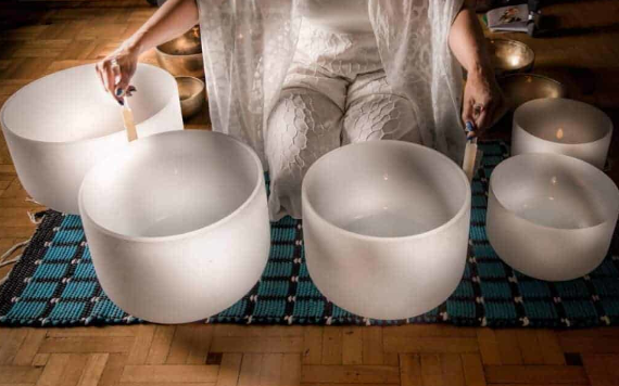 A person making music with Crystal Singing Bowls