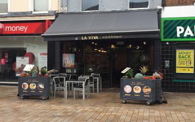 A view looking at the outside entrance to La Viva with seating area