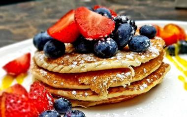 A plate of pancakes, strawberries and blueberries from Moka on the Balcony