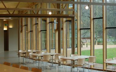 A view of a seating area next to large windows inside the Pavilion Café