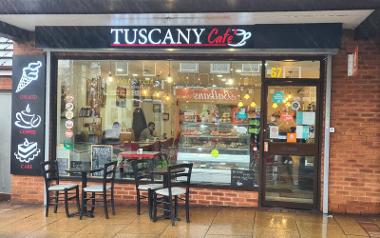 Seating tables under a canopy outside Tuscany Café