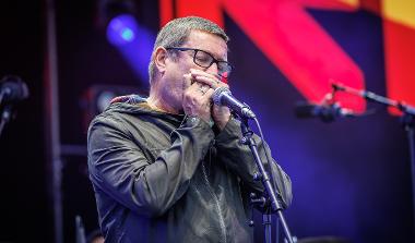 Paul Heaton performing on stage