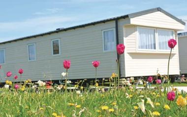 Flowers outside a static caravan at Beacon Fell View Holiday Park