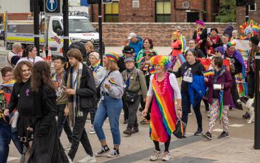 A group of people in the parade walking down Friargate with the Pride Parade