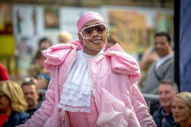 A lady in a pink outfit with sunglasses on during the Family Catwalk event at Encounter Festival 2024