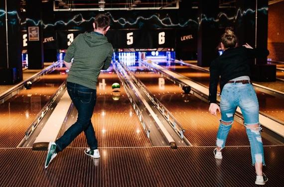 People enjoying a game of bowling at Level