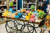 Jellycat toys displayed on a vintage cart