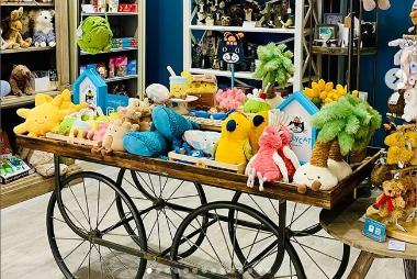 Jellycat toys displayed on a vintage cart