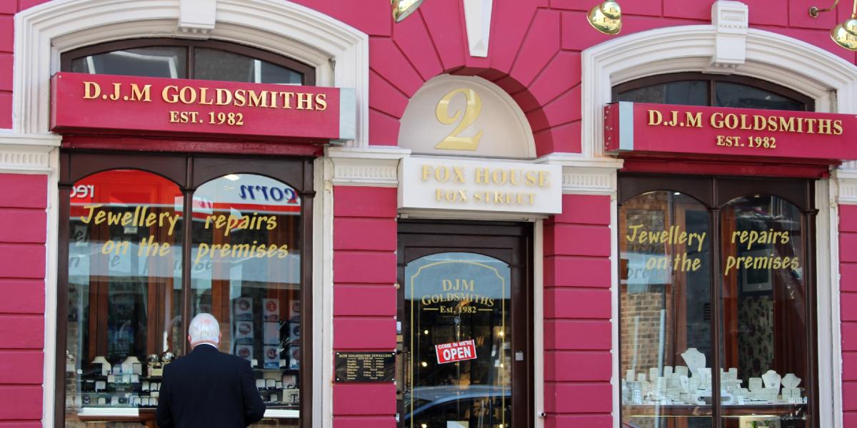 Main image: Man looking into the window of an independent jewellery shop. Man looking into the window of an independent jewellery shop.