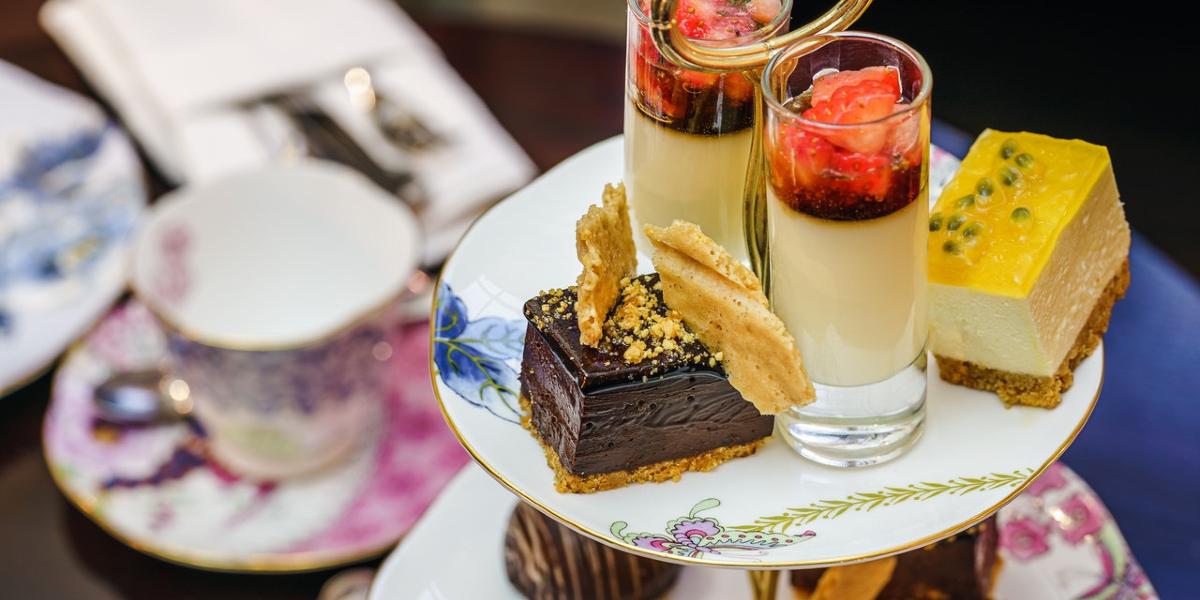 Afternoon tea, with desserts and cakes, displayed on a table.