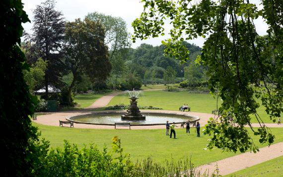 Group gathered around fountain in Miller Park, Preston.