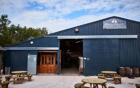 Outdoor seating and Brindle Distillery exterior