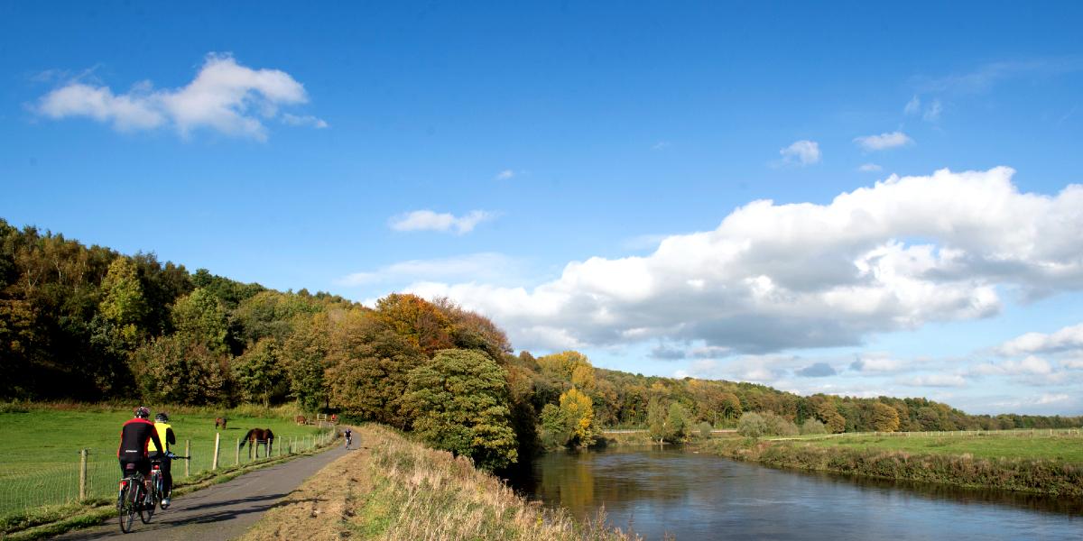 Cyclists along Preston Guild Wheel next to the River Ribble.