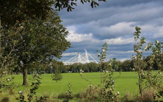 View of Preston North End stadium over the green fields of Moor Park.