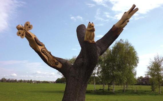 Tree carved into sculptures of animals at the end of each bough.