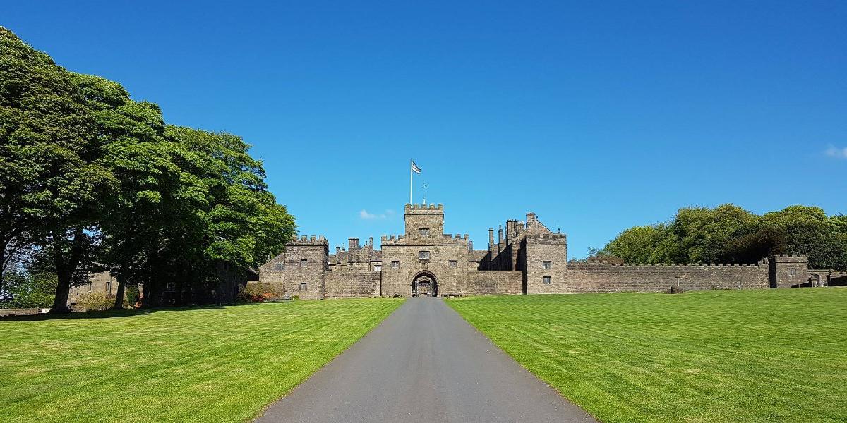 Long pathway, with grass on either side, leading to entrance to Hoghton Tower, Preston.