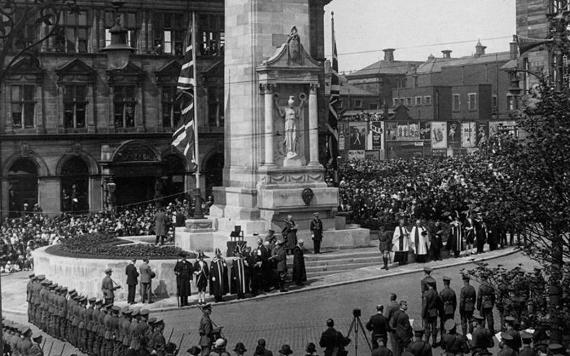 Old black and white photo of crowds surrounding the Preston Cenotaph during a service.