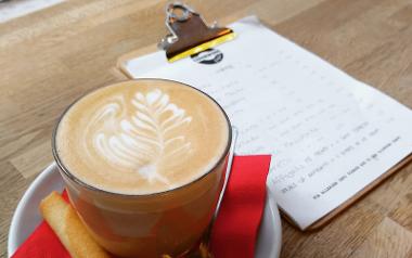 Coffee and menu on table inside Cedarwood Coffee Co.