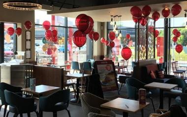 Balloons and seating inside Costa at Preston's Queen's Retail Park.