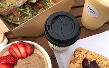 Food and drink from Origin Juice and Brew Bar arranged on table.