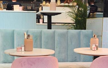 Pastel pink and blue seating inside Rise.