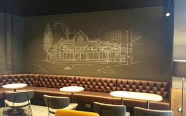 Seating and buildings drawn on wall inside Starbucks Fishergate, Preston.