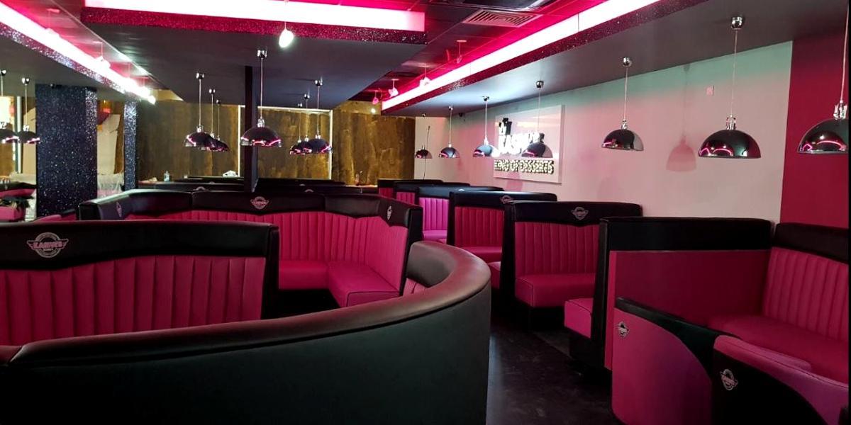 Pink and black booths inside Kaspa's Preston.