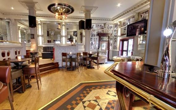 Hartley's Wine Bar indoor seating with high ceilings, mirrors, and traditional decor.