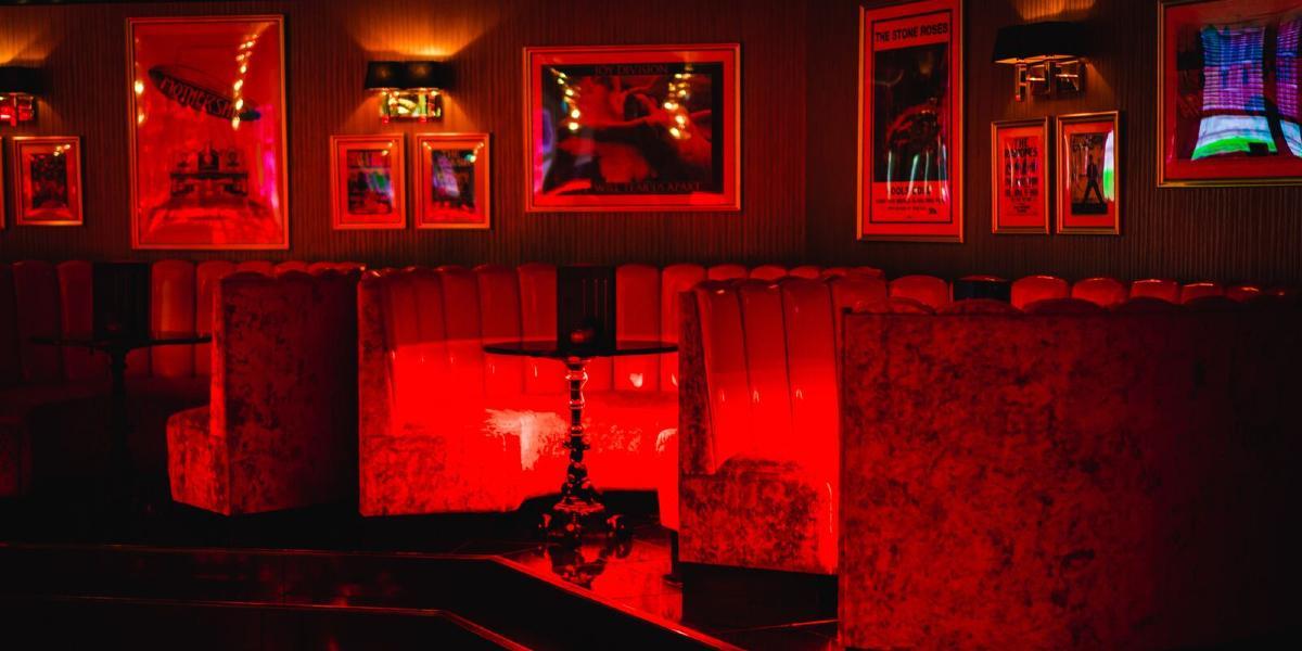 Booths lit up in red inside Kuckoo Preston.