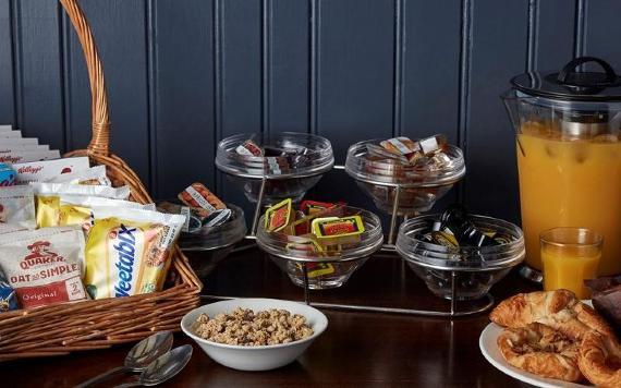 Lea Gate breakfast buffet table with croissants, juice, and cereals.