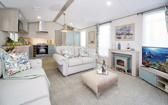 Neutral open plan living room and kitchen inside Mowbreck Caravan Park caravan.