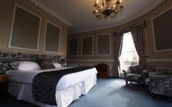 Large hotel room with chandelier and velvet chairs at Shaw Hill Hotel.