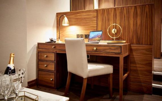 Hotel at Mill Farm wooden desk, and Champagne in foreground.