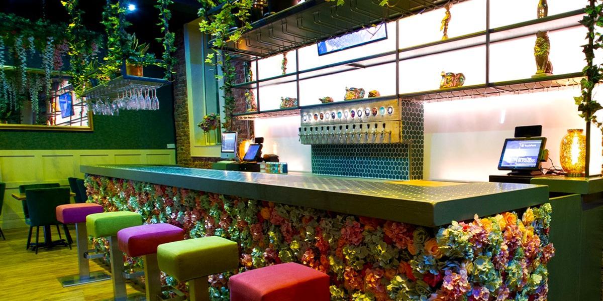 Florianas bar area, decorated in brightly coloured faux flowers.