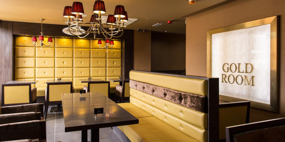 Gold and maroon interior and seating inside Haute Dolci dessert house, Preston.