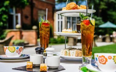 Afternoon tea at Bartle Hall displayed on a table outdoors on a sunny day.